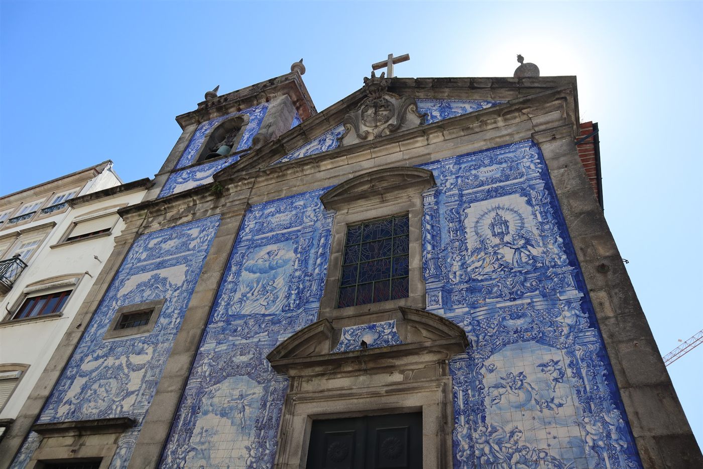 Blue and white azulejo tiles covering the facade of a chapel in Porto