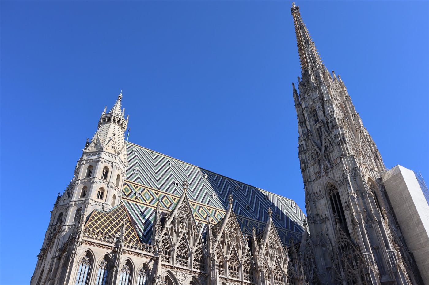Zigzag patterned tile roof and Gothic spire of St. Stephen's Cathedral in Vienna