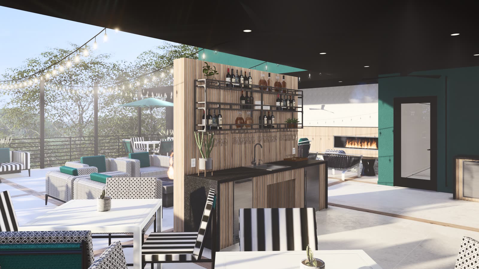 A covered roof terrace: a timber and steel bar with open bottle shelving, a linear fire beyond it, dining and lounge seating either side and the view out over the treeline