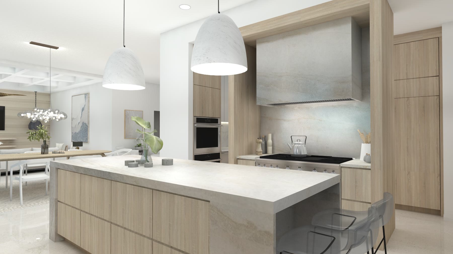 The kitchen at Waterfront Residence: a marble island under paired pendants, pale timber cabinetry and the sea through full height glazing